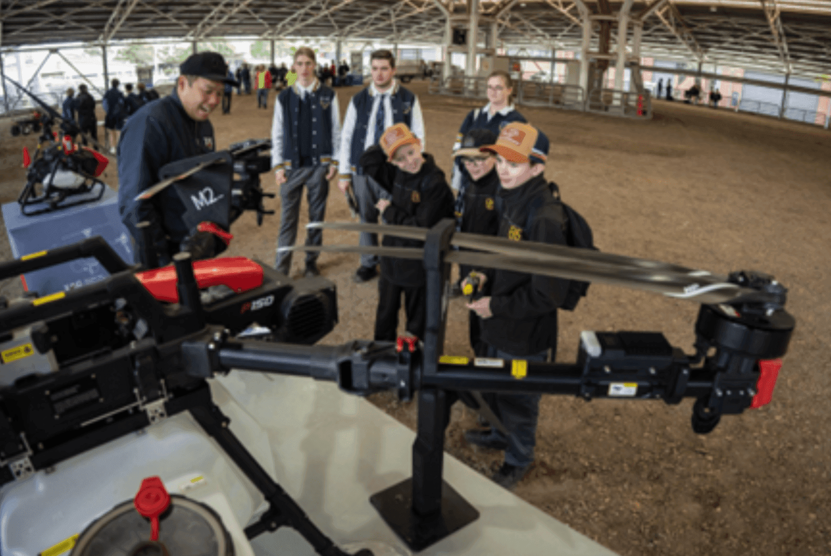 A group of people standing around a machine