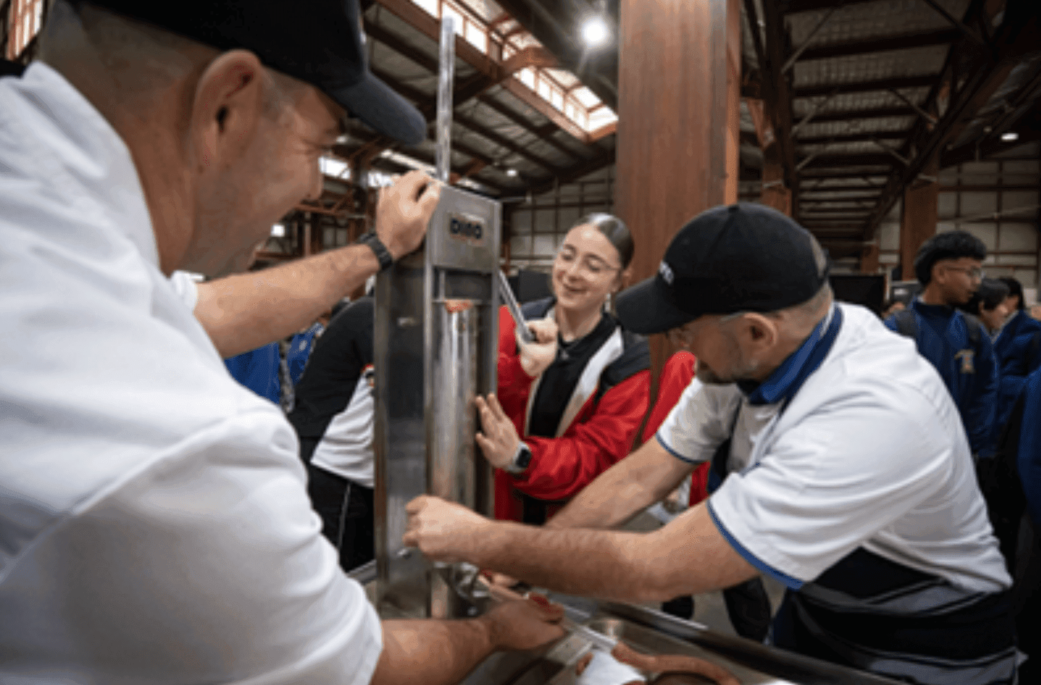 A group of people working on a machine