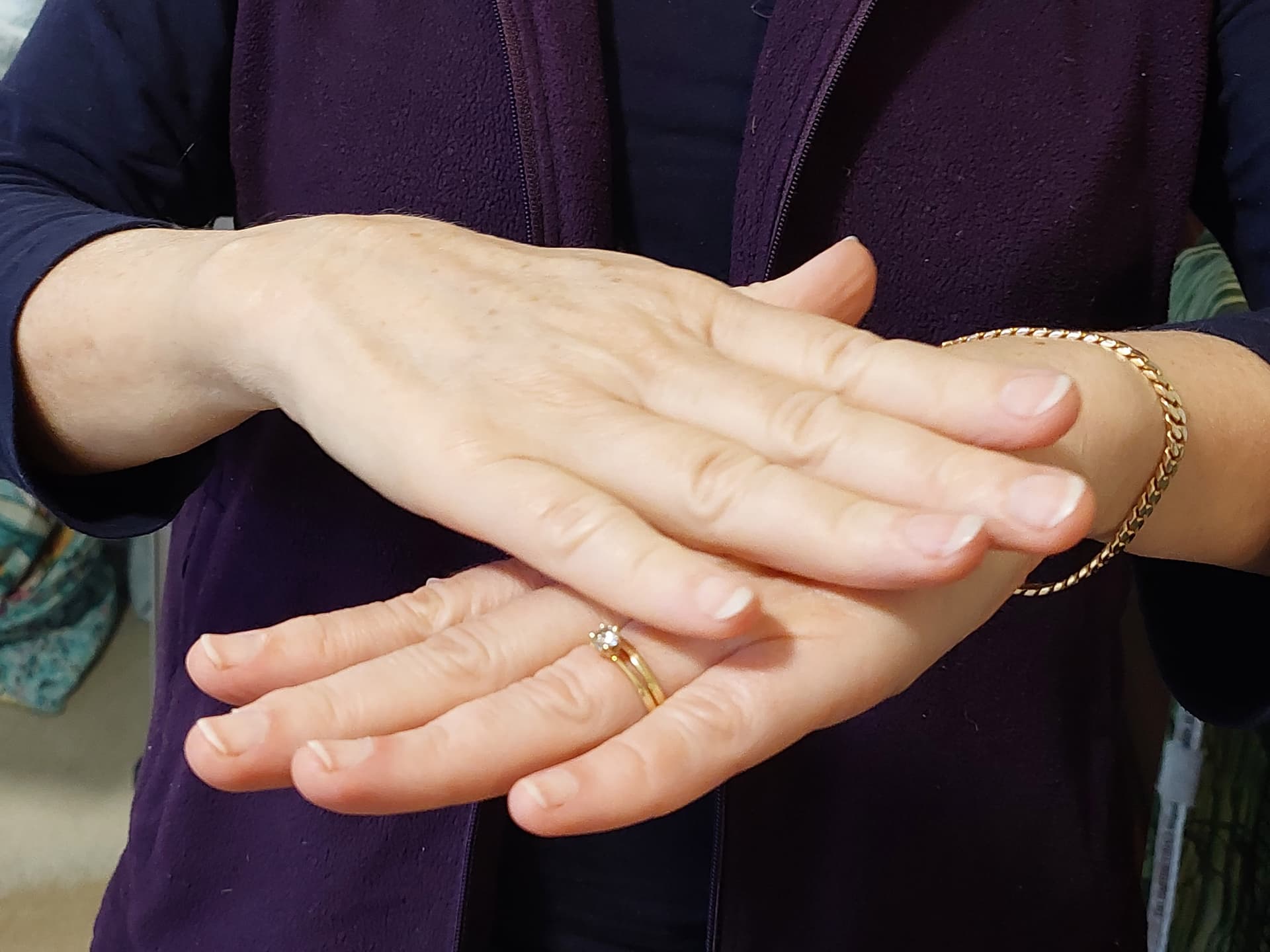 A woman is holding out her hand with a ring on it