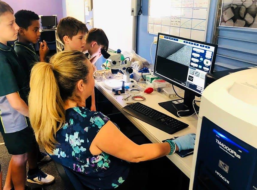 A group of people in a lab looking at a computer screen