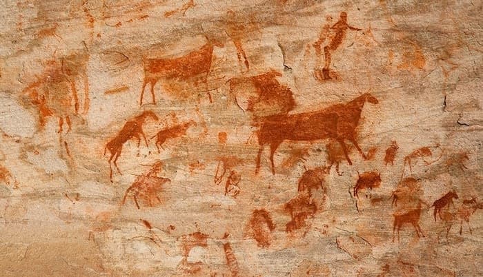A group of animals painted on a rock wall